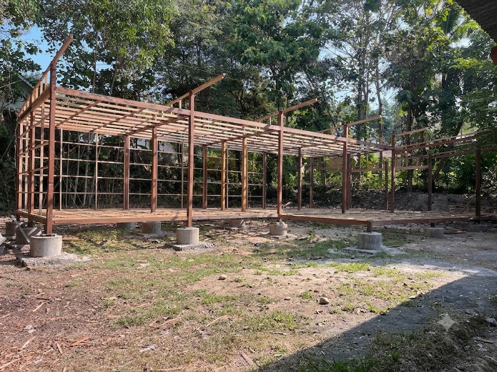Mila Resort villa under construction, glue-laminated teak frame with steel connector plates on concrete point foundations